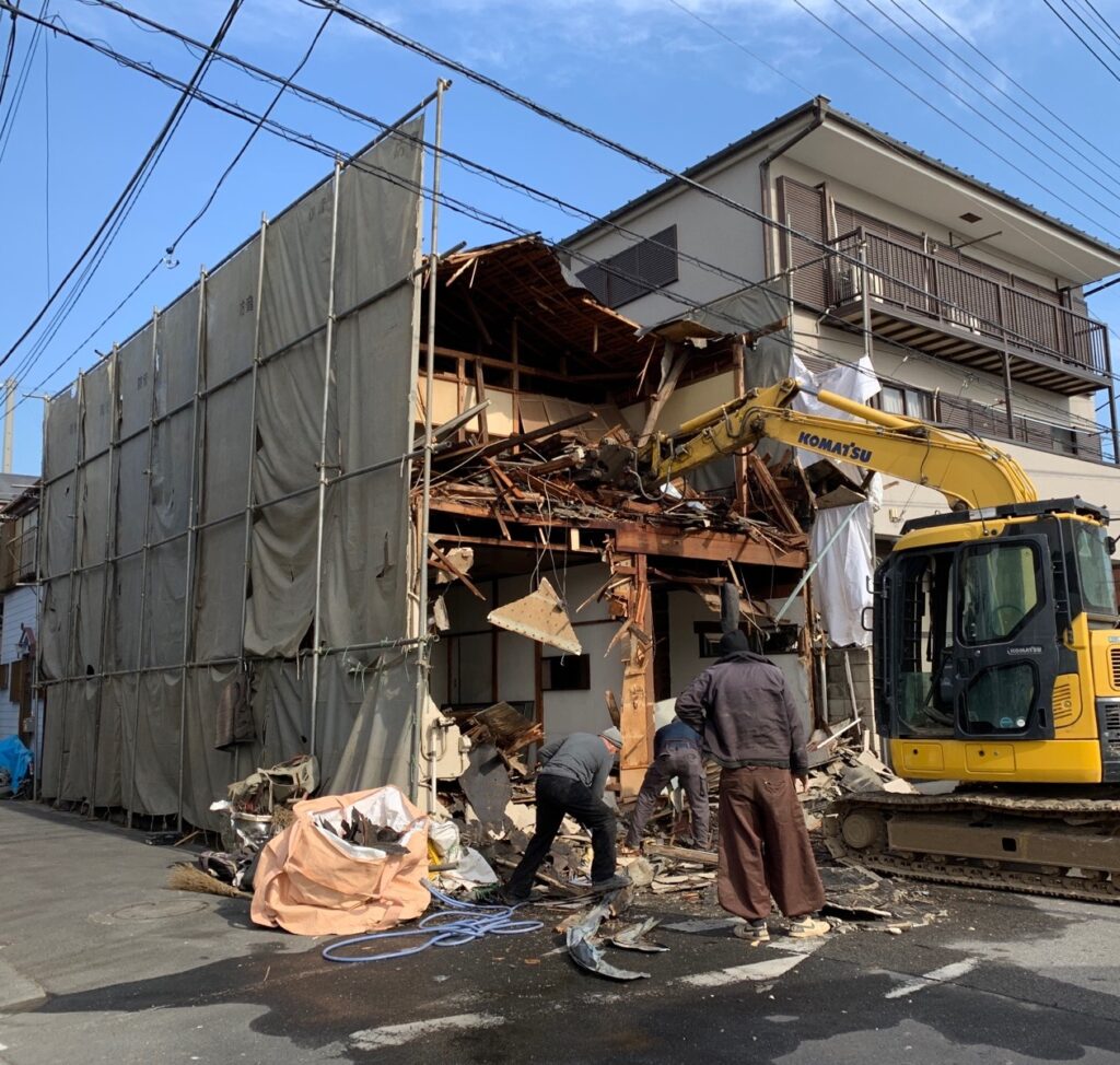 養生シートの外に飛び出した廃材